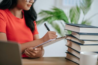 A woman working through a checklist at a desk