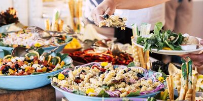 People serving themselves from a catering table after a service